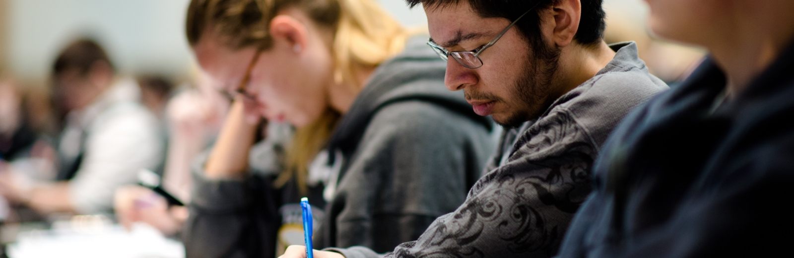 Students taking notes in a classroom setting