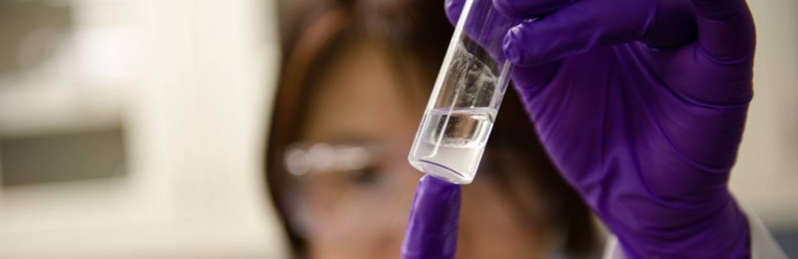 Female student holding up viles in Yoke Khin Yap Research Laboratory