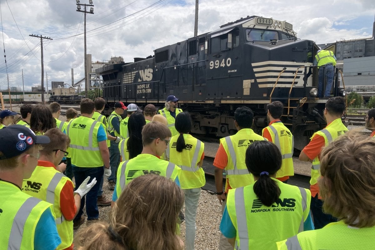 Large group outside visiting Norfolk Southern engine.
