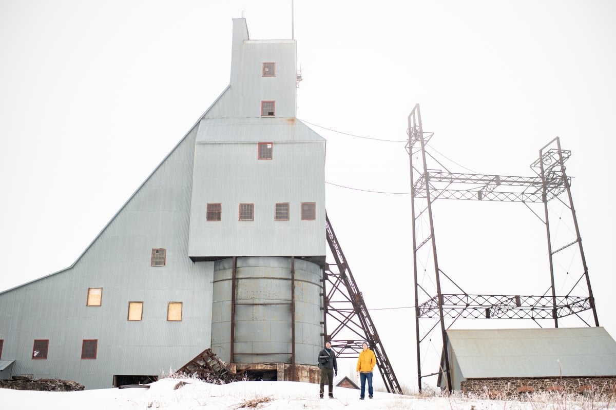 From copper mines to groundbreaking designs—Houghton has seen it all. Two people stand outside the Quincy Mine hoist.
