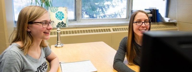 Student working with their advisor on a class schedule.