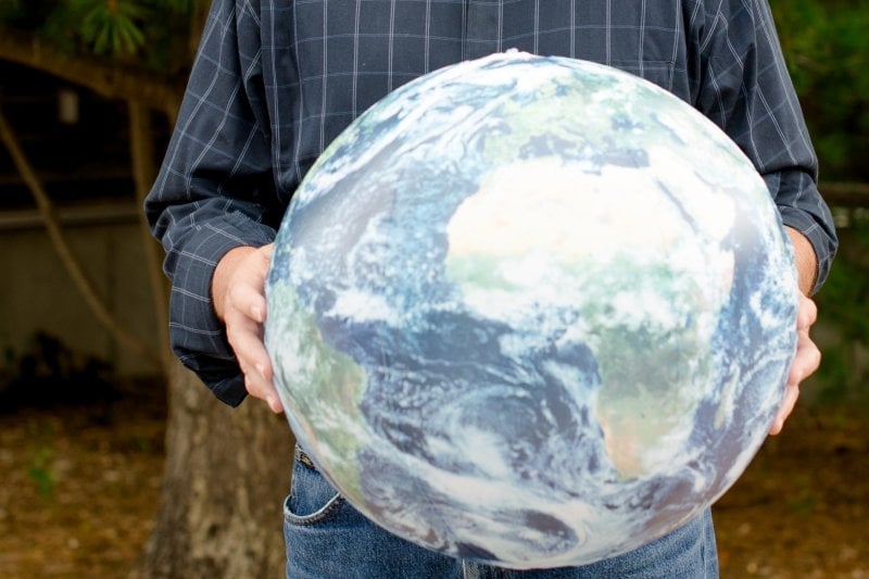 Man holding globe. 