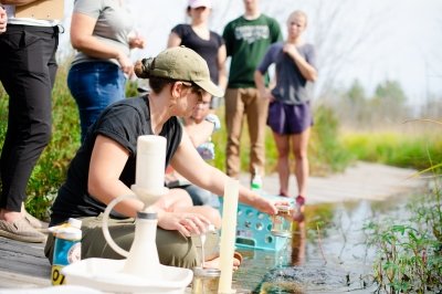 A researcher is collecting and analyzing water samples from a small river