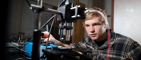 A man adjusts the levels on a sensor.