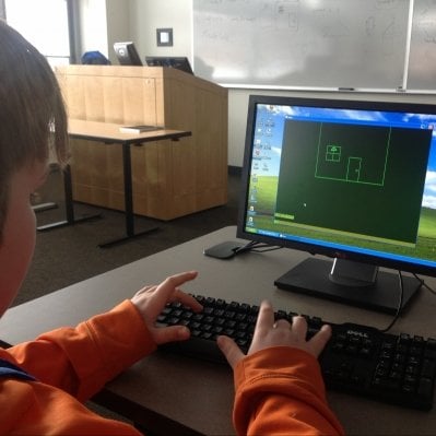 Male student working on a drawing on the computer