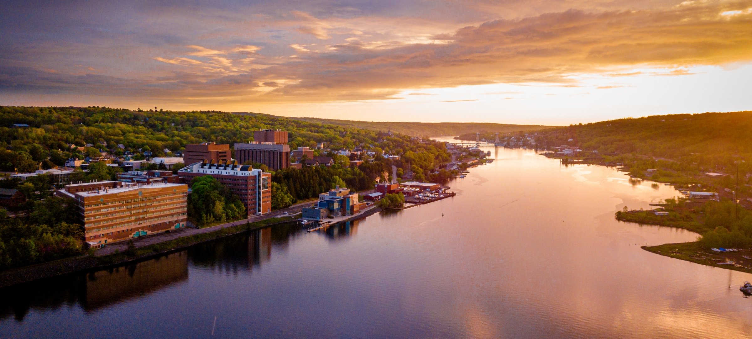 sunset over Portage Canal with MTU campus in foreground