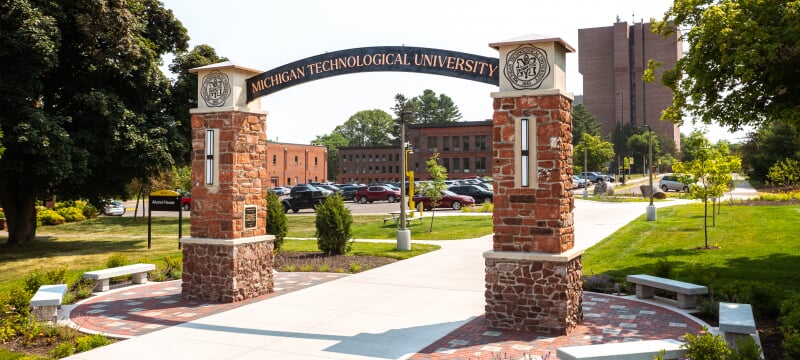 brick archway over sidewalk with Michigan Technological University on arch