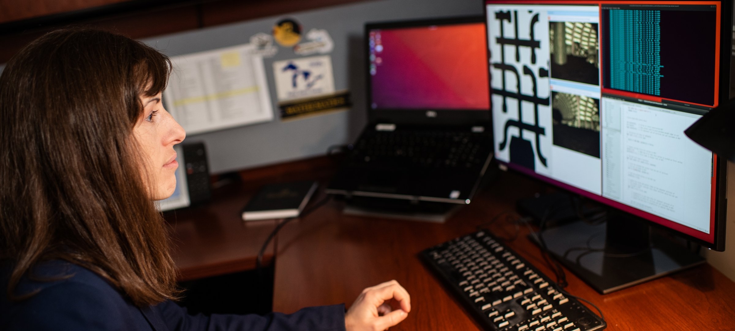 Researcher sitting at a computer with research data