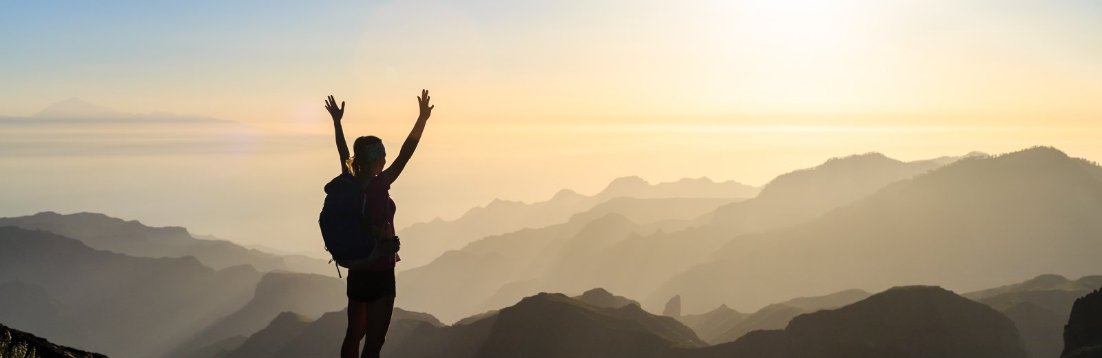 Climber on top of a mountain