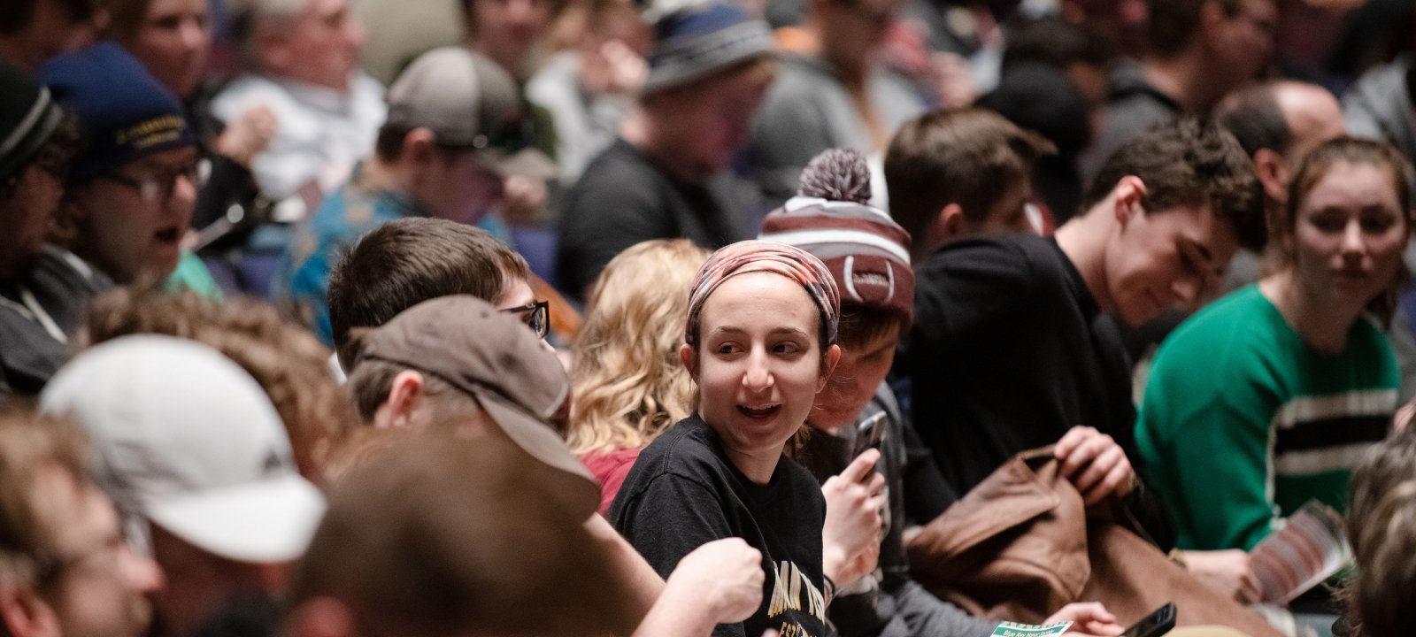 Audience members interacting with each other before a performance.