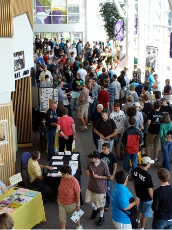 Lobby full of patrons looking a displays during an exhibition event.