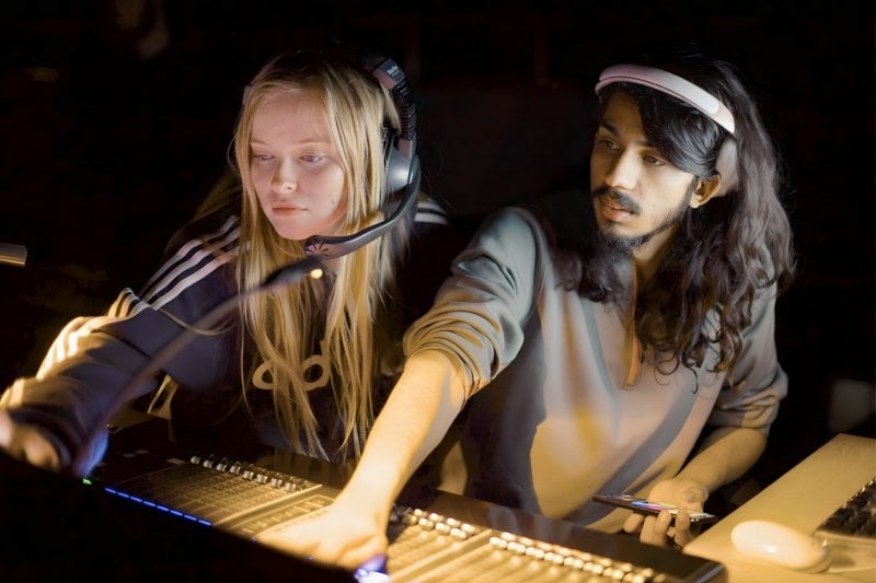 Student adjusting audio in a sound booth during a Rozsa Performance