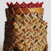 Woven basket with yarn, wood, and bark