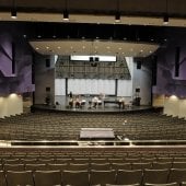 Inside the Performance Hall, looking at the stage from the back tier