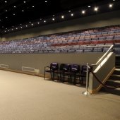 Inside the Performance Hall, showing the view of the middle aisle with usher seating and sound board