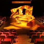 Inside the McArdle Theatre during a dressed set with a golden light shining on the set