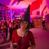 Patron in a witch's hat posing for a photo.