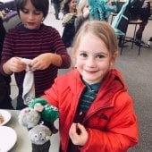 Girl works on creating a puppet.