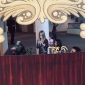 Three children perform a play in the puppet theatre.