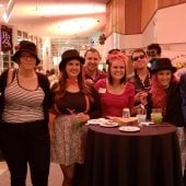 Group of party guests pose for a photo in the Samuel and Grace Horner Lobby.