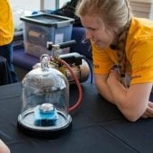 Young student looking at a experiment with Mind Trekkers.