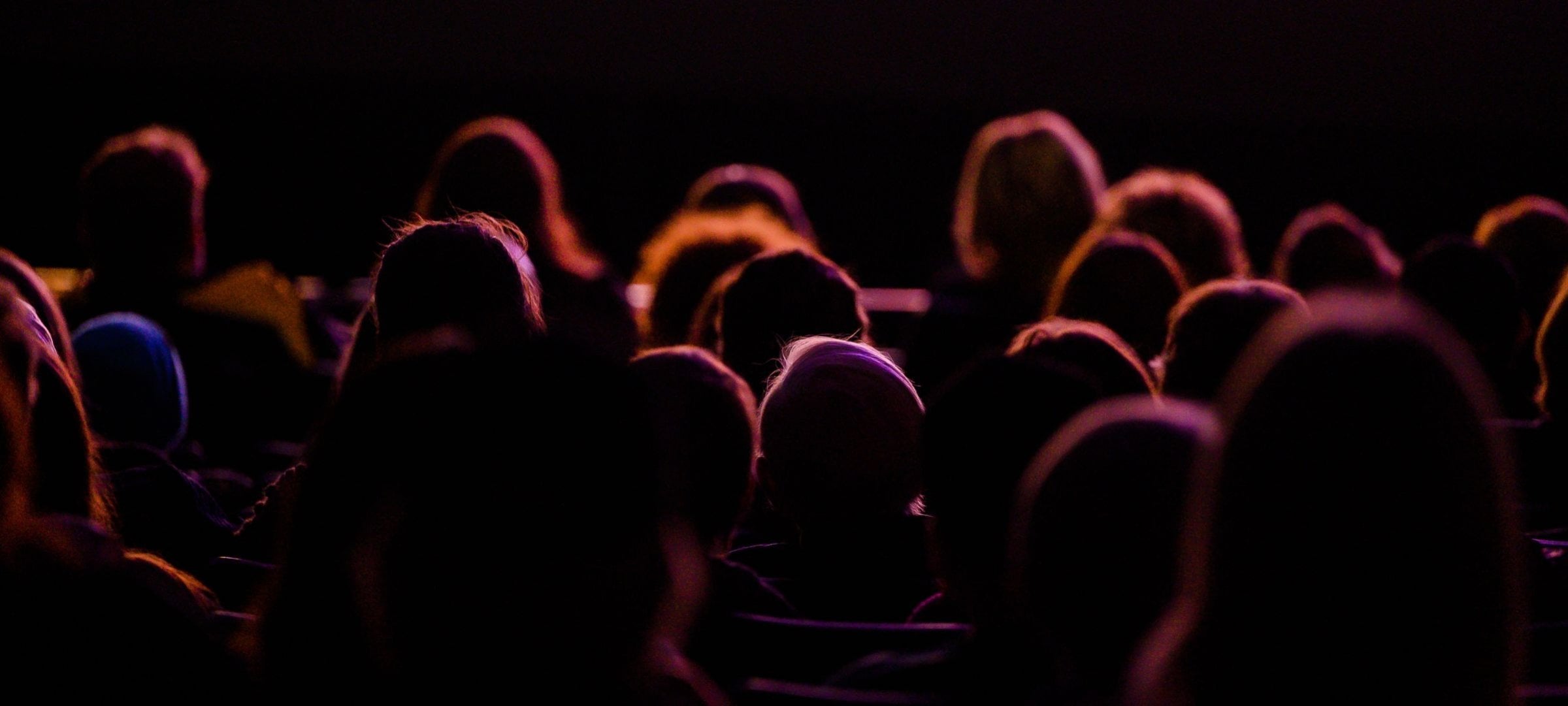 Backlit audience watching a performance at the Rozsa Center