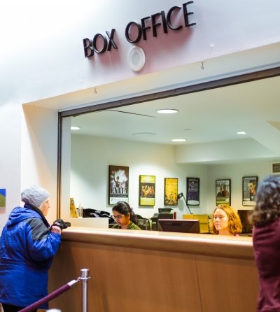 A guest talks with the Box Office staff