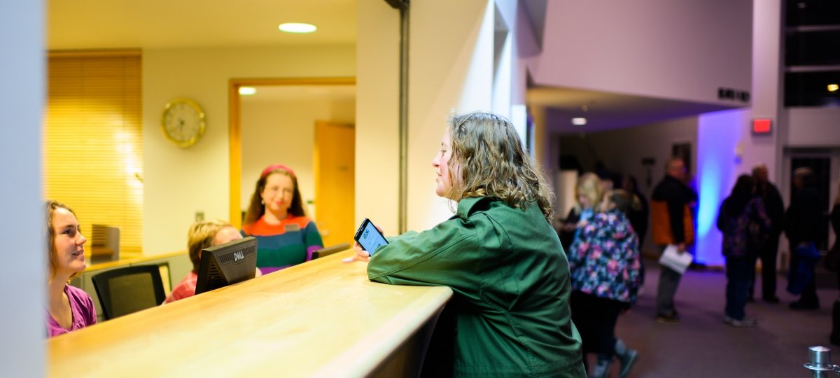 A ticket buyer talks with box office staff