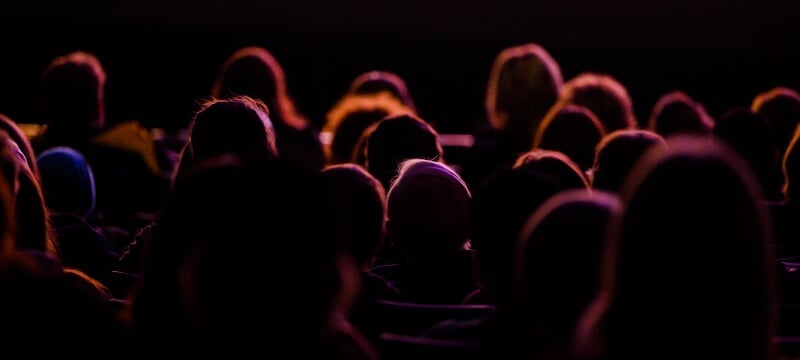 Audience members at the Rozsa backlit by the stage