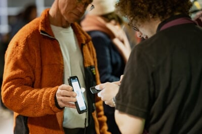 Rozsa volunteer usher scanning a mobile ticket on audience member's smart phone