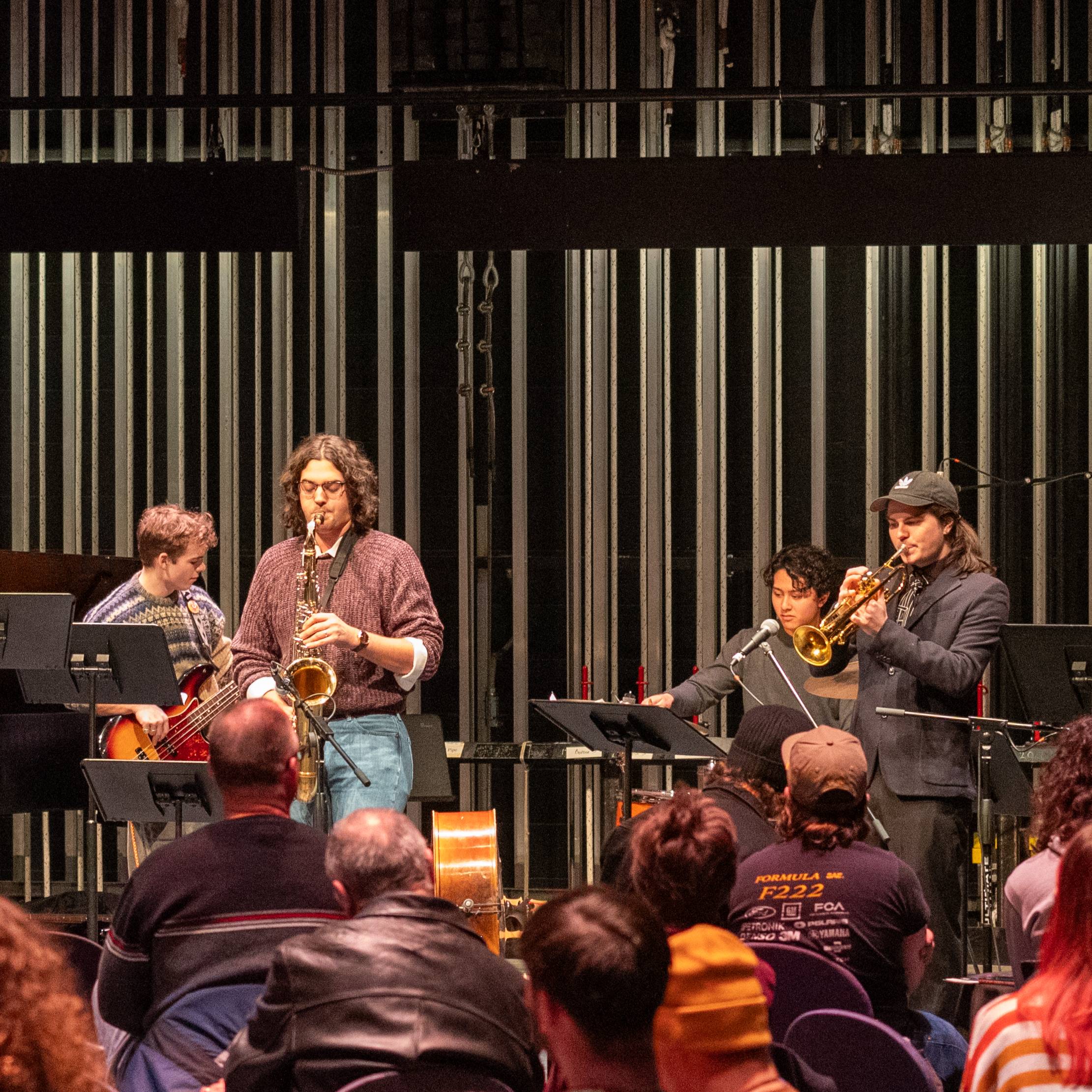 Four members of Jaztec perform in a backstage setting