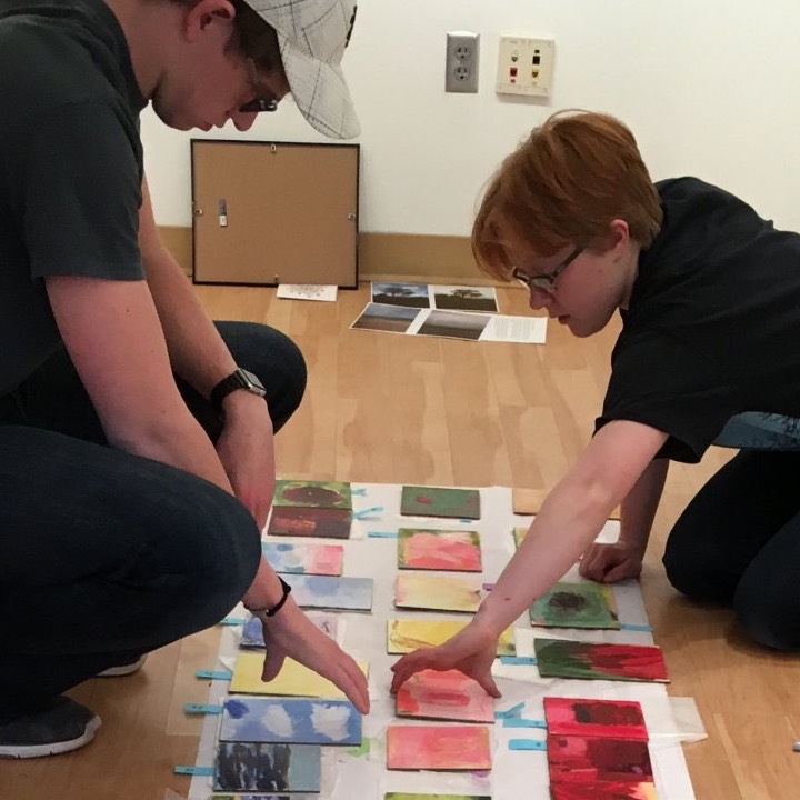Two students decide on paintings