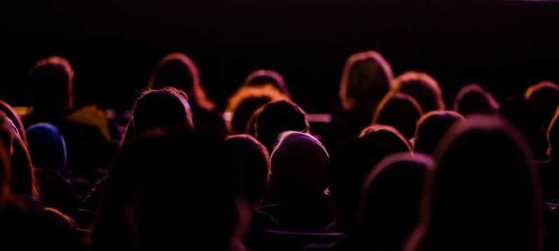 Backlit audince watching a performance at the Rozsa