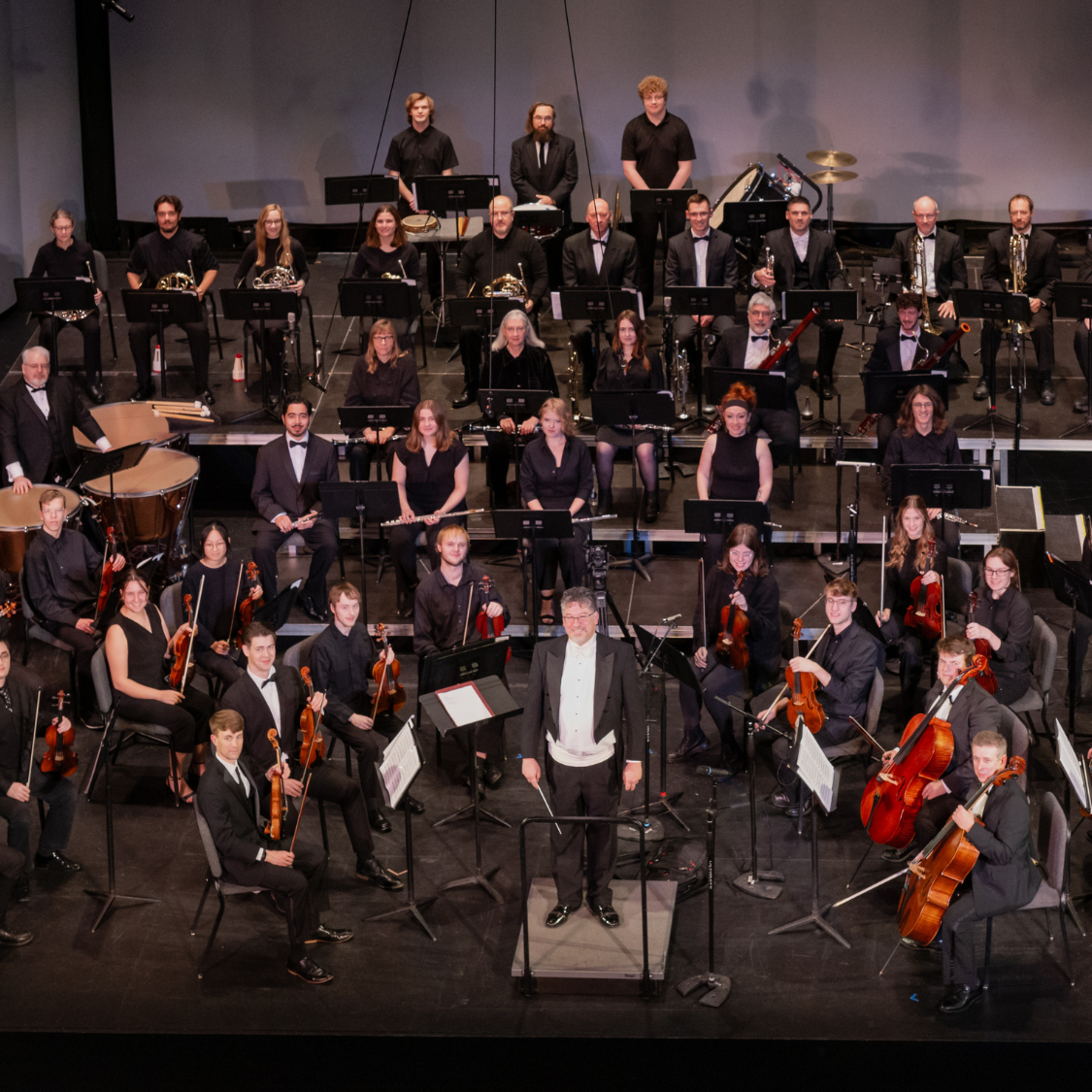 The Keweenaw Symphony Orchestra poses on stage