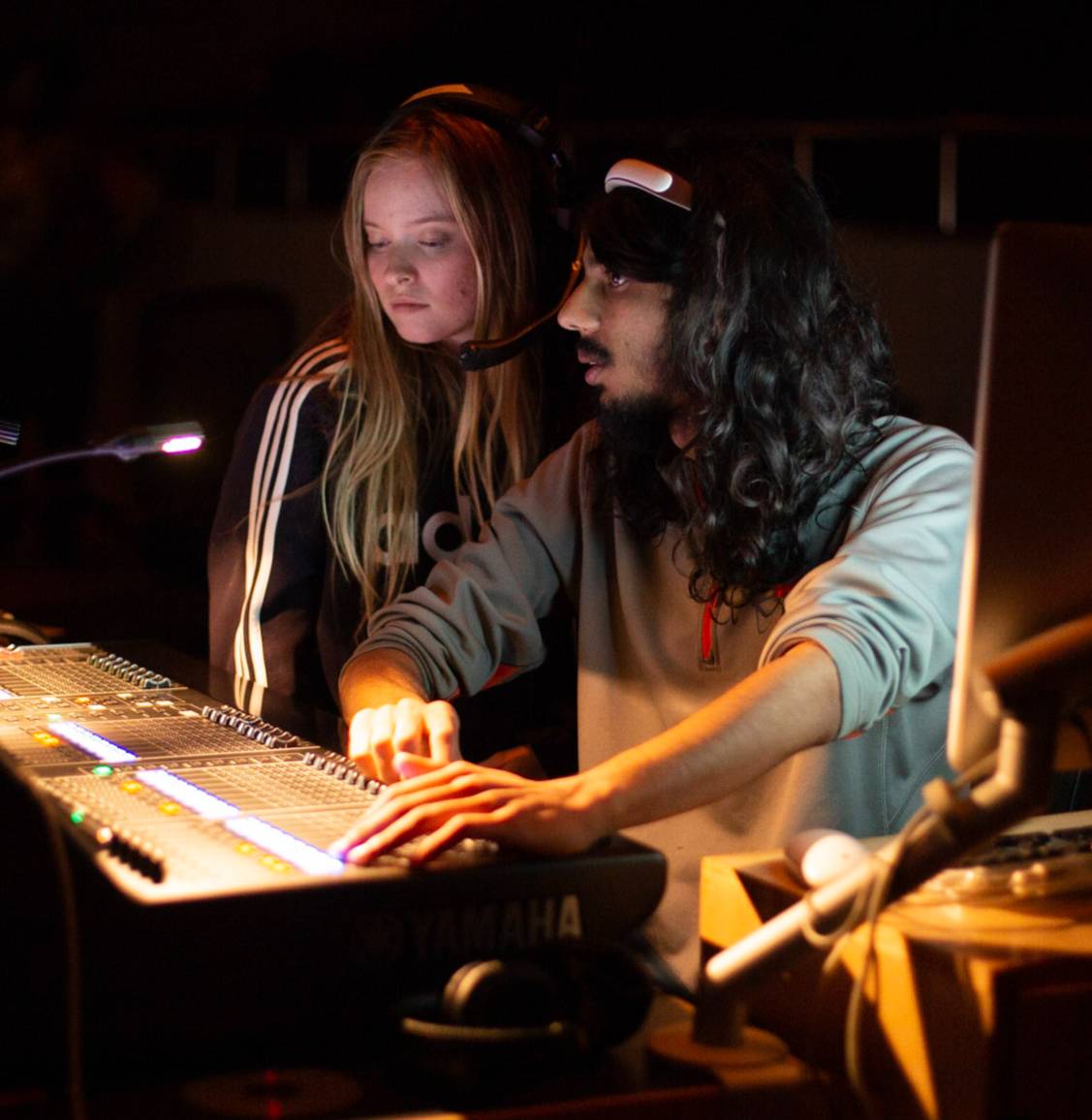 Visual and Performing Arts Department students work at a sound board. 