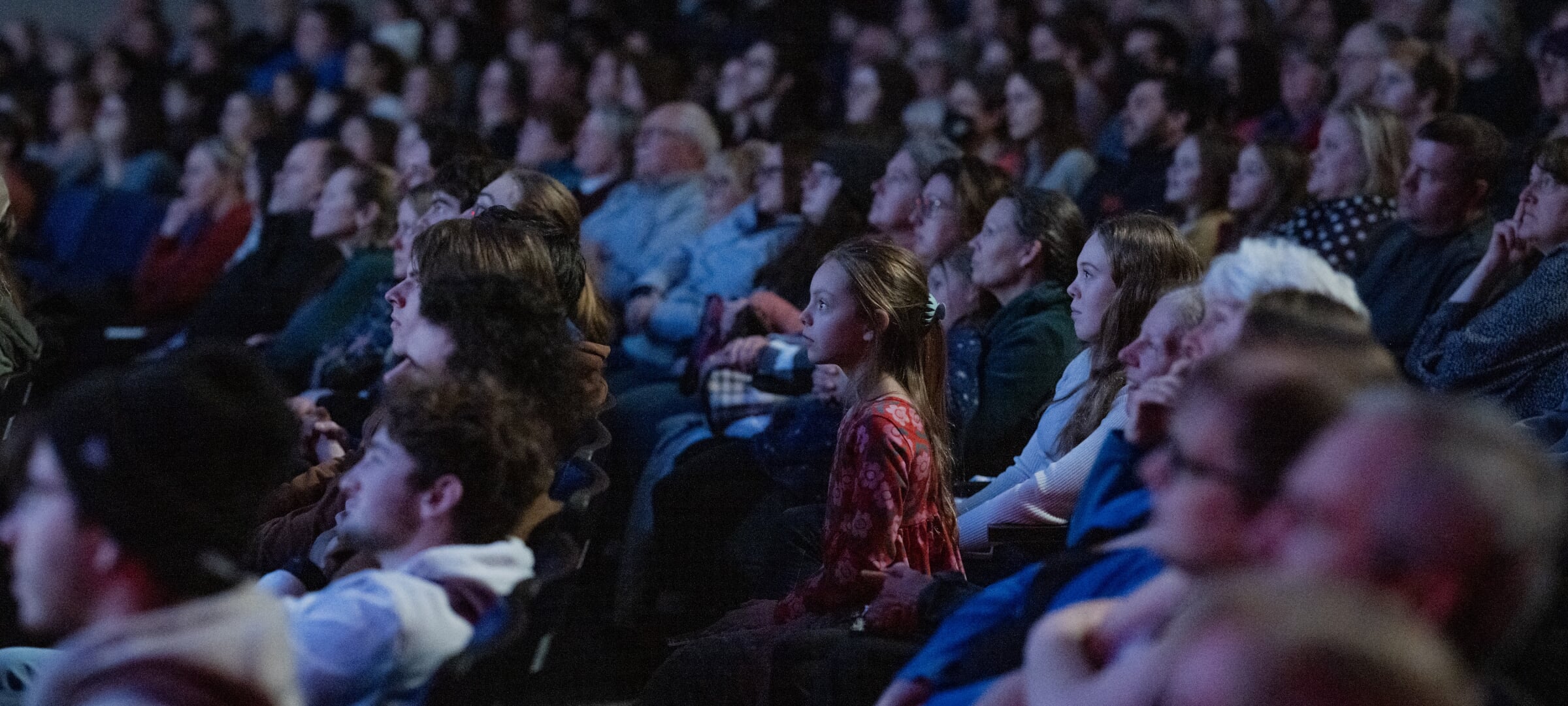 A full audience at the Rozsa Center with child on the edge of seat