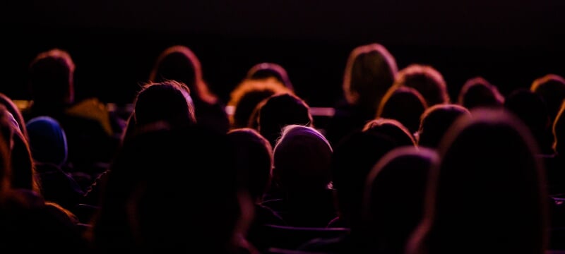 Backlit audeince facing the stage at the Rozsa Center
