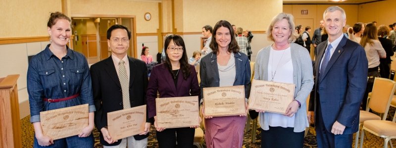 College of Sciences and Arts Faculty posing for a picture with their awards.