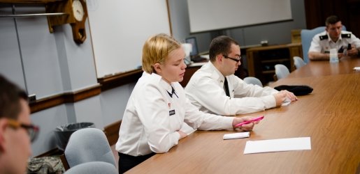 Two cadets seated around a conference table