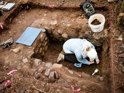 Michigan Tech student digging for artifacts