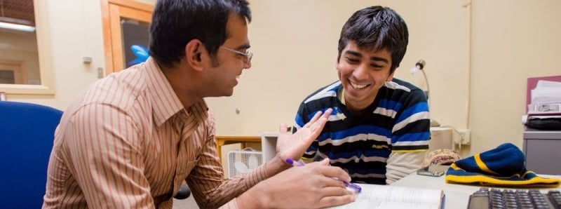 Two students discussing research.