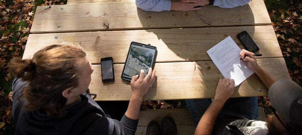 Students sit at picnic table