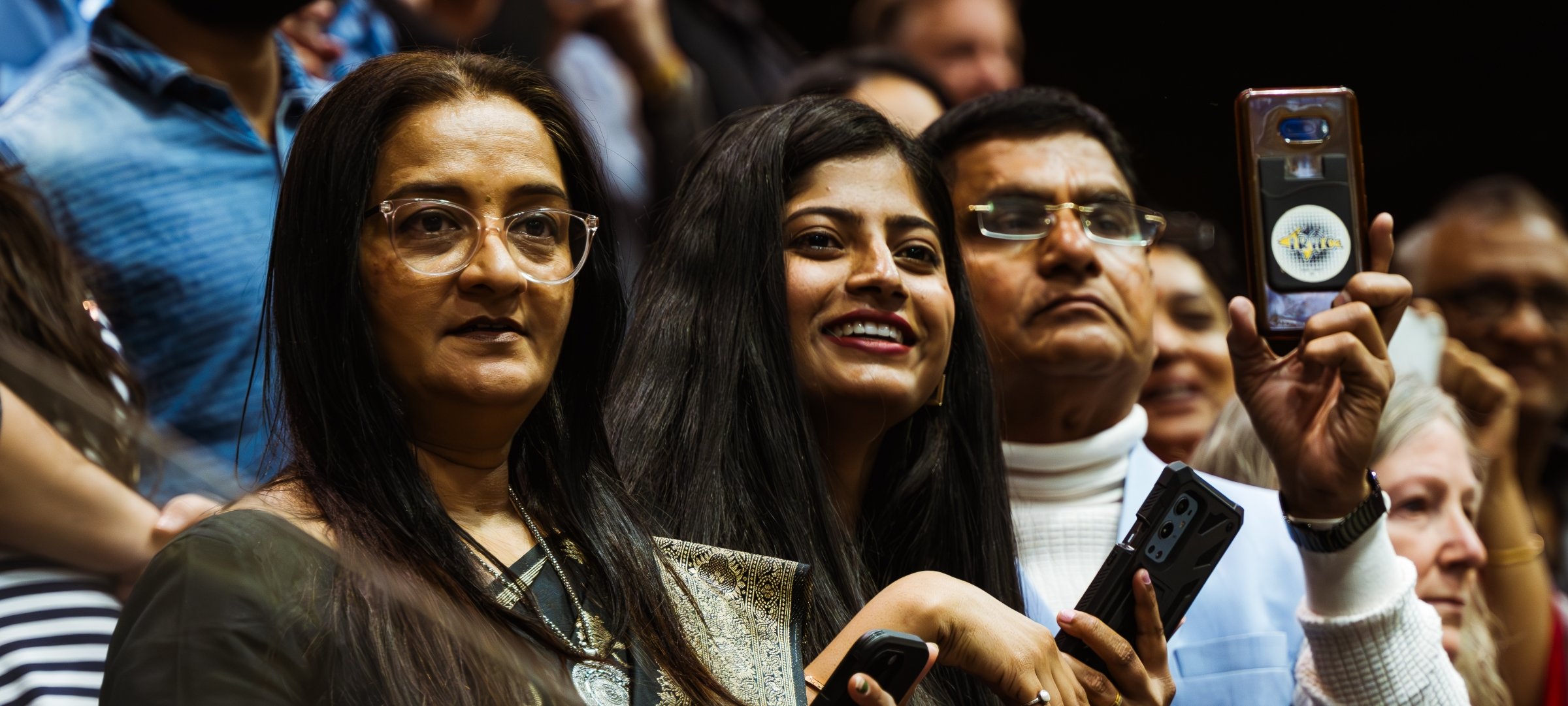 Parents using phones during a commencement ceremony