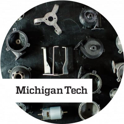 Various pieces of equipment aligned on a black surface with black text reading Michigan Tech overlaid on white