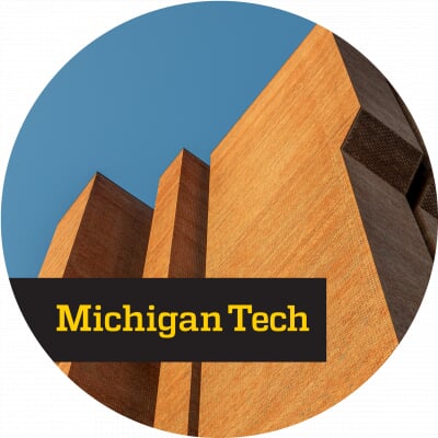 View from the bottom of the R. L. Smith Building looking up with yellow text reading Michigan Tech written on top of a black background