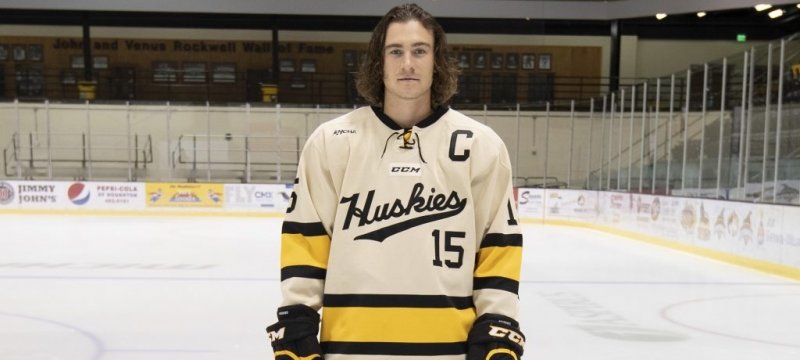 Jake Lucchini in his hockey gear standing on the ice.