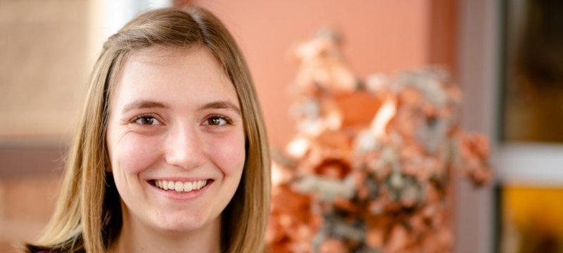 Katie Kring with a large piece of copper in the background.