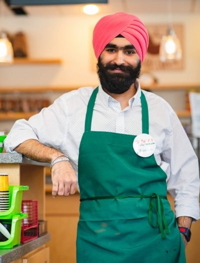 Maneet Singh wearing a green apron and Taylor 2.0 nametag.