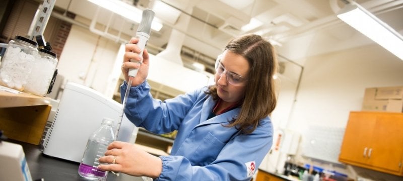 Rebecca Ong preps a switchgrass sample in the lab.