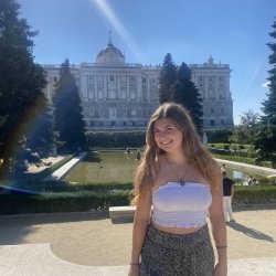 A Husky Abroad smiles as she stands in front of the Palace of Madrid.